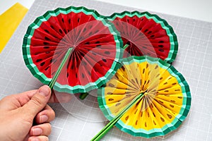 DIY instruction. Step by step tutorial. Making decor for summer birthday party - red and yellow watermelon fan. Craft photo