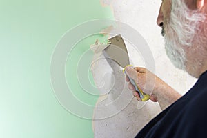 DIY man wallpaper stripping