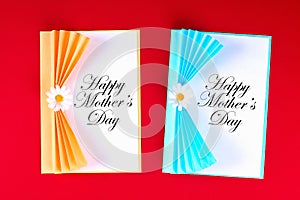 Diy Mothers Day greeting card in the form of curtain with paper chamomile flower on red background