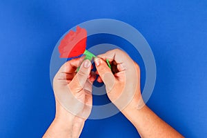 Diy paper red poppy Anzac Day, Remembrance, Remember, Memorial day crepe paper on blue background