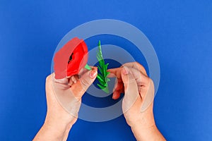 Diy paper red poppy Anzac Day, Remembrance, Remember, Memorial day crepe paper on blue background