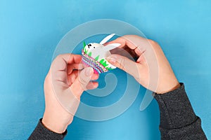 Diy rabbit from easter eggs on blue background. Gift ideas, decor Easter, spring. Handmade