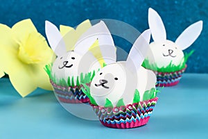 Diy rabbit from easter eggs on blue background. Gift ideas, decor Easter, spring. Handmade