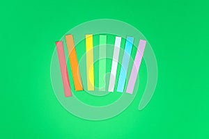 DIY rainbow colored paper, cotton wool cloud St Patricks Day green background