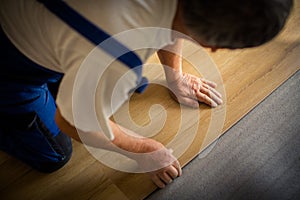 Close up of male hands lying parquet floor