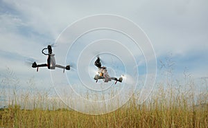 DIY tricopter drone flying, low pass above the grass field