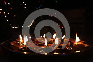 Diya / lamps lighting on a tray on diwali festival