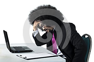 Dizzy Afro businessman working with laptop