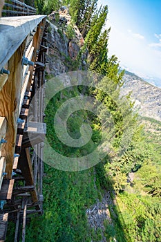 Dizzying look to mountain rocky profile with steep slope down to the canyon