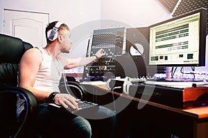 DJ adjusts equipment in sound recording studio