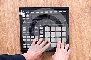 a dj audio producer fingers play the drum music on pads of drum machine