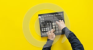 a dj audio producer fingers play the drum music on pads of drum machine