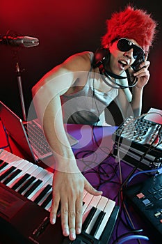 Dj with colorful light and music mixing equipment