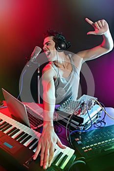 Dj with colorful light and music mixing equipment