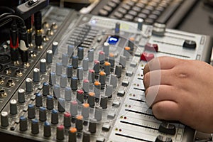 Disk jokey adjusting the music volume