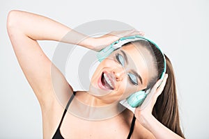 Dj girl. Close up portrait of excited young woman relaxed with great song in headphones, listens music, dancing and