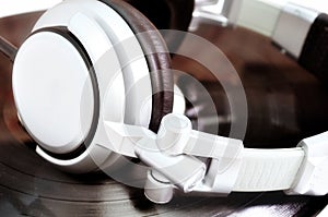 DJ headphones lying over old vinyl