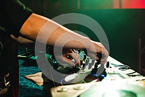 DJ mix music hands in night club at event on mixer