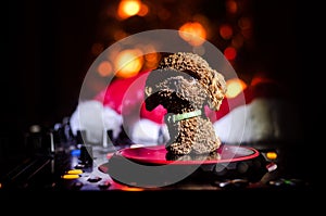 Dj mixer with headphones on dark nightclub background with Christmas tree New Year Eve. Close up view of New Year elements or symb