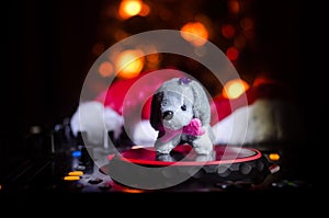 Dj mixer with headphones on dark nightclub background with Christmas tree New Year Eve. Close up view of New Year elements or symb