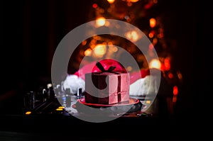 Dj mixer with headphones on dark nightclub background with Christmas tree New Year Eve. Close up view of New Year elements or symb