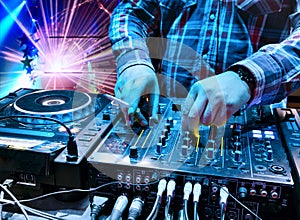 Dj mixes the track in the nightclub