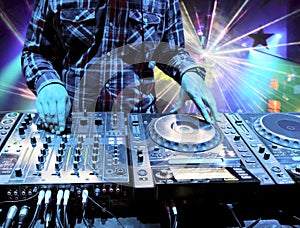 Dj mixes the track in the nightclub