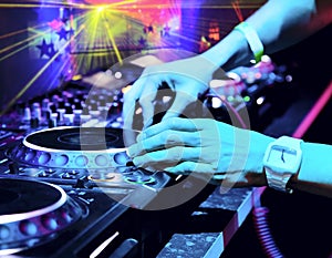 Dj mixes the track in the nightclub