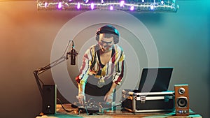 DJ musician using turntables to mix techno sounds