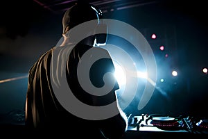 Dj in a nightclub scene with lights and lasers. Night scene of electronic music over the audience and crowd