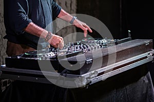 Dj playing disco house progressive electro music at the concert. DJ hands on equipment photo