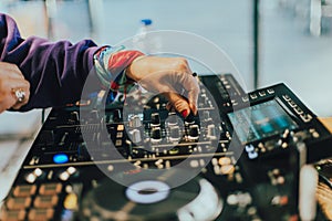 Dj playing disco house progressive electro music at the concert. DJ hands on equipment