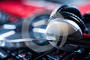 DJ playing music at mixer closeup and mixes the track in the nightclub