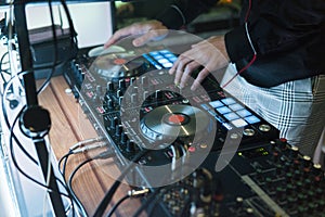 DJ plays and mix music on digital mixer controller. Close-up DJ performance controller, digital midi turntable system