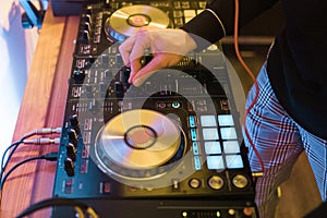 DJ plays and mix music on digital mixer controller. Close-up DJ performance controller, digital midi turntable system