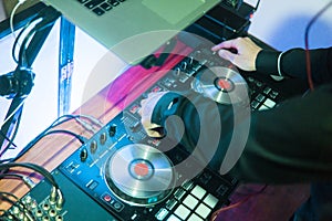 DJ plays and mix music on digital mixer controller. Close-up DJ performance controller, digital midi turntable system