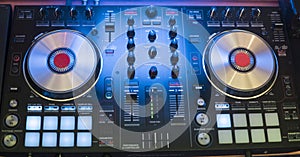 DJ plays and mix music on digital mixer controller. Close-up DJ performance controller, digital midi turntable system