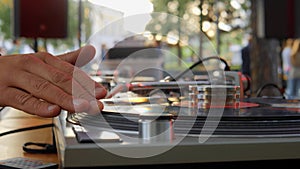 DJ plays a set at a party. Open Air on the summer terrace of a nightclub.