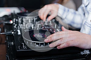 DJ& x27;s hands mix music on the mixer close-up. DJ mixer, DJ mix music on the console, the DJ& x27;s hand.