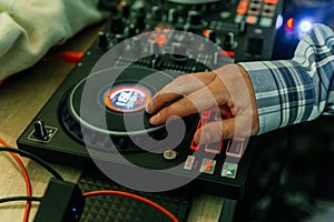 DJ& x27;s hands mix music on the mixer close-up. DJ mixer, DJ mix music on the console, the DJ& x27;s hand.