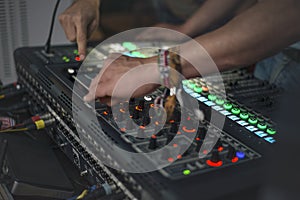 DJ tuning sound electronic equipment before a musical performance.