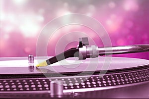Dj turntable with pink bokeh background