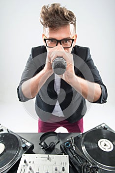 DJ in tuxedo holding microphone and headphones