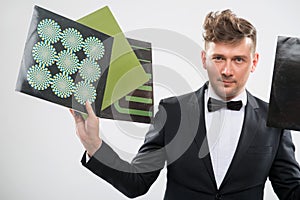 DJ in tuxedo showing his vinyl records standing by