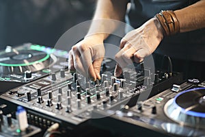 DJ using sound controller to mix music