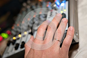 DJ working on a audiomixer at a nightclub
