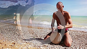 Djembe Drum Player beat rythm on the lonely beach