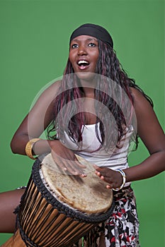 Djembe drummer on green
