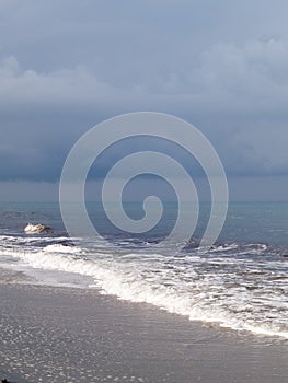 Djerba, Tunisia, beach with sea and waves, cloudy sky