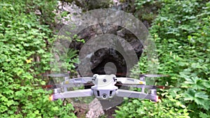 DJI Air 2S quadcopter hovers in front of the cave
